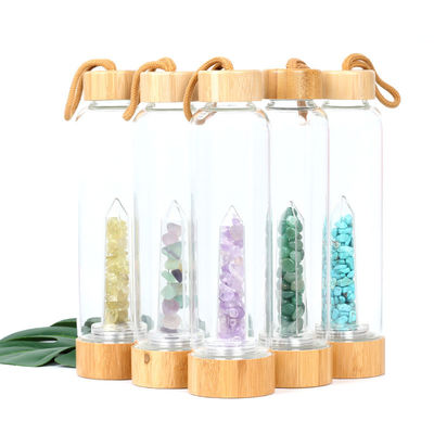 Круглая стеклянная бутылка с водой с естественным кристаллическим пунктом Кристл элексира центра драгоценной камня поставщик