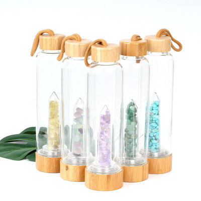 Круглая стеклянная бутылка с водой с естественным кристаллическим пунктом Кристл элексира центра драгоценной камня поставщик
